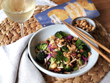 |A bottle of Clif Family Rte Blanc Sauvignon Blanc sits on a bright and airy kitchen counter space with a tray of sushi. A hand reaches into frame holding a pair of chopsticks.