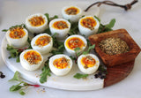 A platter of hard-boiled eggs topped with a flavorful dukkah seasoning, made with Clif Family Organic Rosemary Almonds & Pistachios, toasted sesame seeds, cumin, coriander, and fennel. A perfect healthy and protein-packed snack or appetizer.
