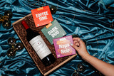 Clif Family's Eat Chocolate, Drink Wine Gift Set on a blue velvet background