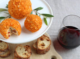 Bacon and Cheddar Cheese Ball|A girl in a floral long sleeved top holds a bottle of Clif Family Bici Rhone-Style Red Wine with the sun shinning.